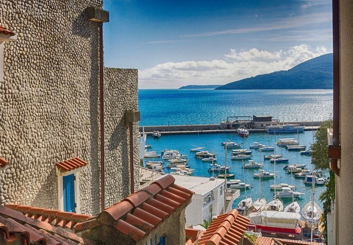 Photo Herceg Novi view from narrow streets to the blue water Photo Herceg Novi view from narrow streets to the blue water